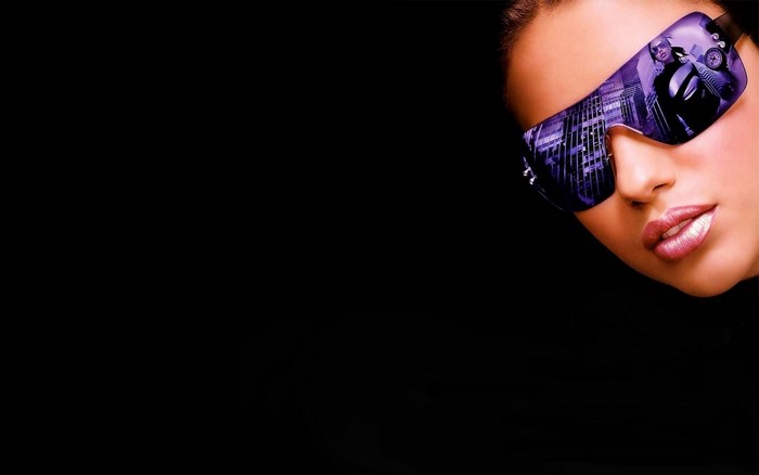 Woman wearing stylish sunglasses with city reflection