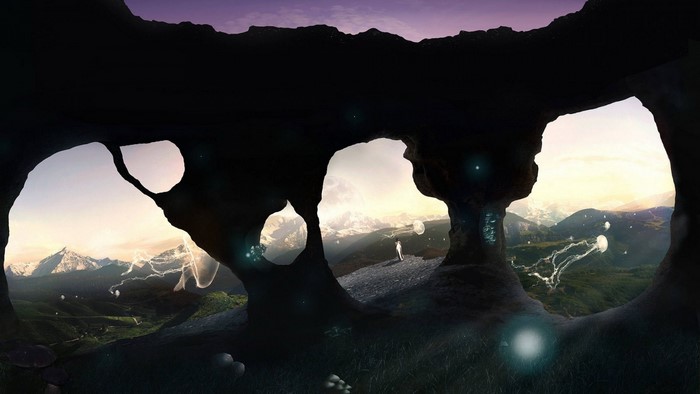 Cave opening overlooking a mountain landscape with glowing jellyfish