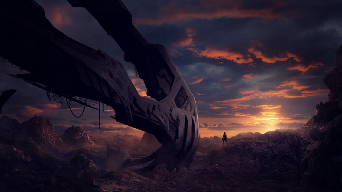 A lone figure stands before a colossal alien structure at sunset