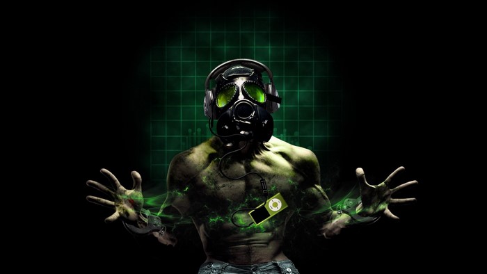 Man in gas mask with headphones and green energy