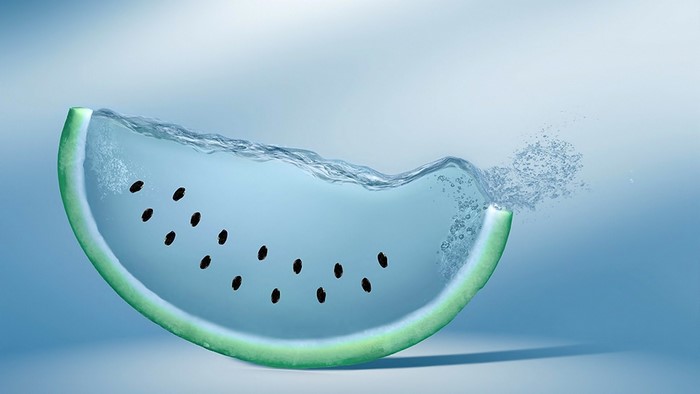 Slice of watermelon filled with water and seeds