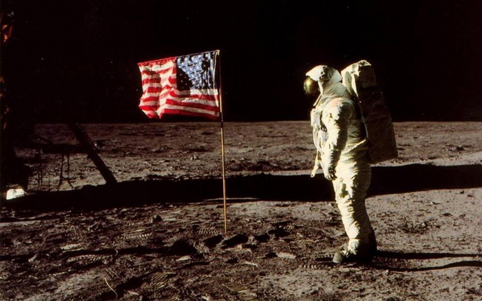 Astronaut planting American flag on the Moon