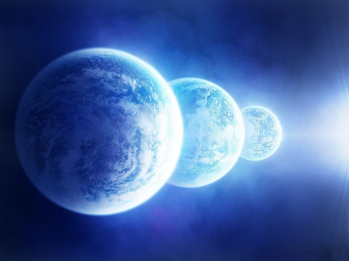 Three planets in space with sunlight