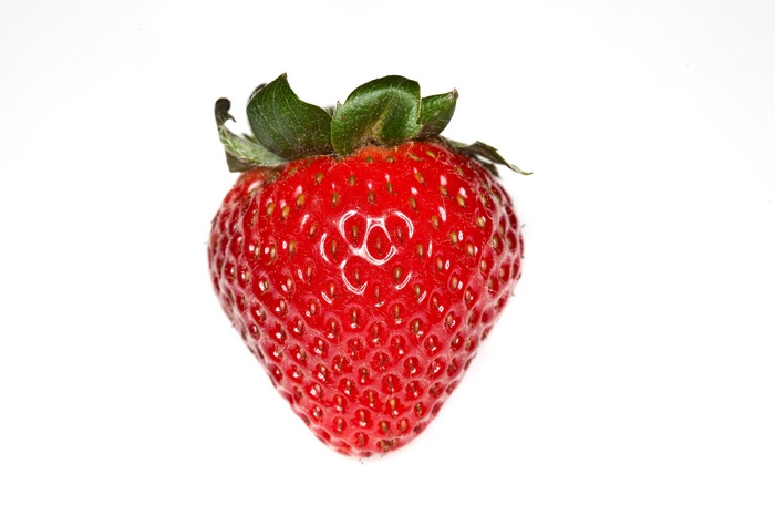 A single ripe strawberry on a white background