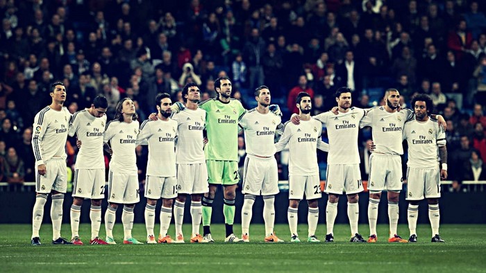 Real Madrid football team standing on a field