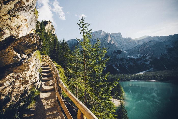 Mountain path overlooking a lake in the Alps