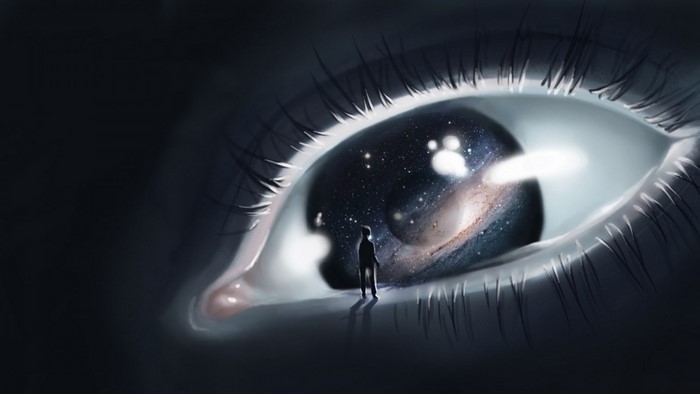 Eye reflecting the universe with a person standing