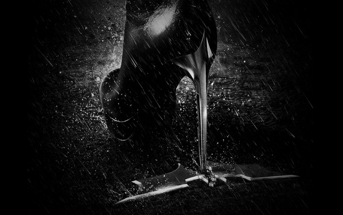Batman logo under a high heel in the rain