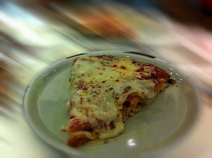 Slice of cheese pizza on a plate