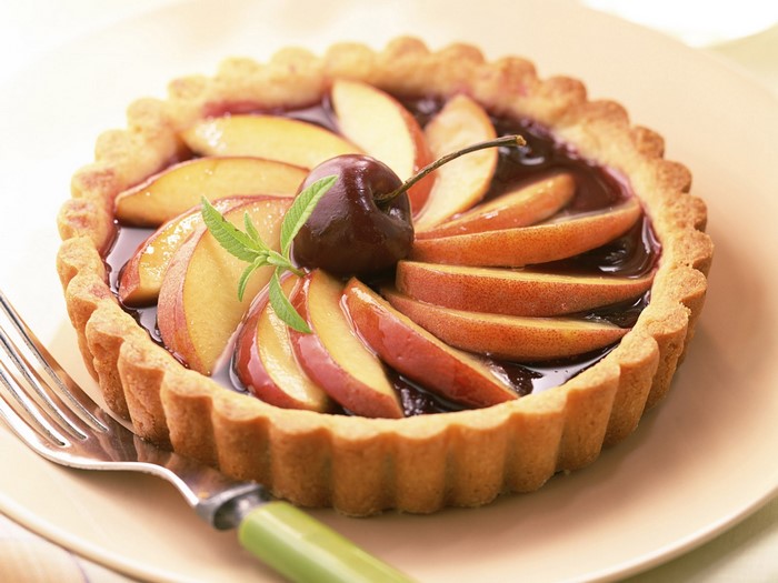 Fruit tart with cherry and sliced peaches
