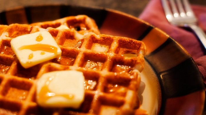 Waffles with butter and syrup on a plate