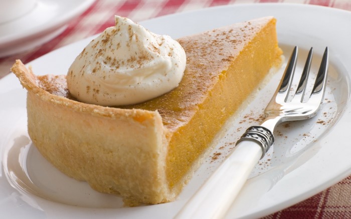Slice of Pumpkin Pie with Whipped Cream and Cinnamon
