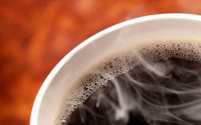 Close up of steaming coffee with foam