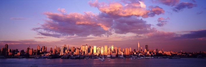 New York City skyline at sunset with colorful clouds