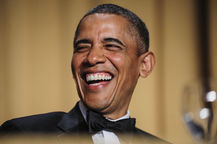 Barack Obama laughing in a tuxedo