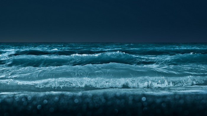 Ocean waves at night with bokeh
