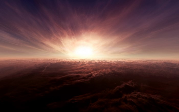 Sunset over clouds with sun rays