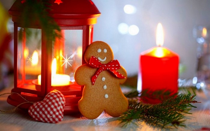 Christmas gingerbread man with red lantern and candle
