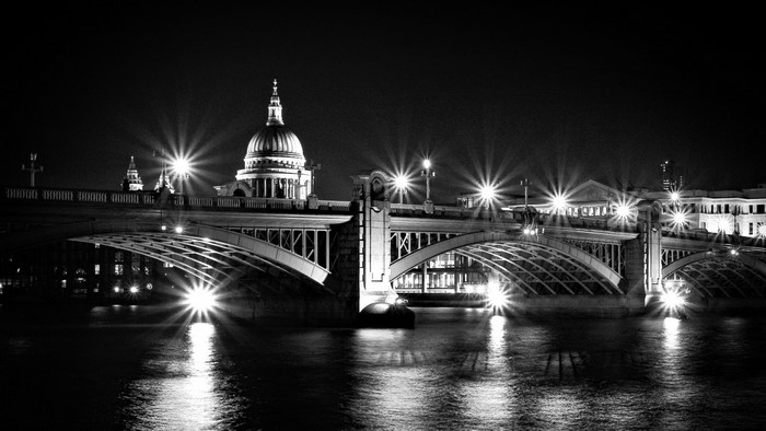 Black and white night view of London Bridge and St. Paul's Cathedral