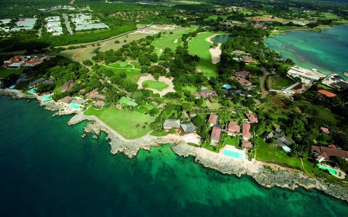 Aerial view of a coastal resort with golf course and ocean