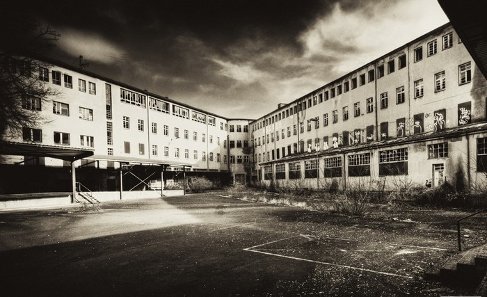 Abandoned building with graffiti and courtyard