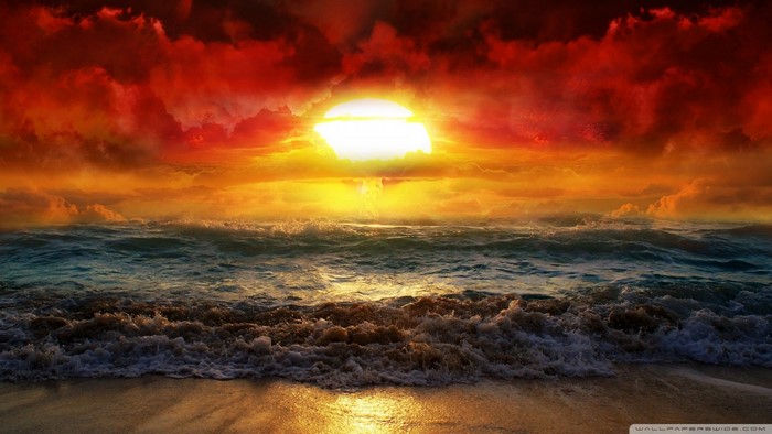 Apocalyptic sunset over the sea with waves crashing on the shore