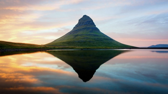 Kirkjufell mountain reflected in water at sunset