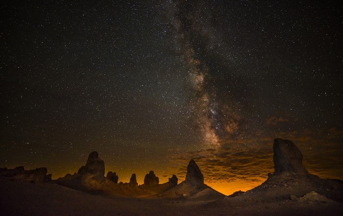Milky Way galaxy over desert rock formations at night