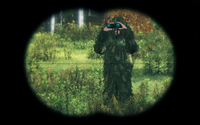 Person in ghillie suit using binoculars in a forest