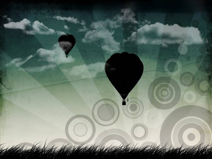 Hot air balloons in a stylized sky with grass