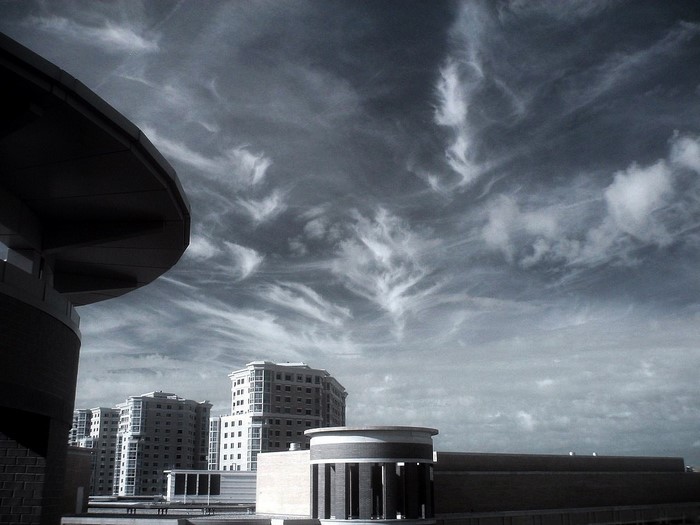 Monochrome view of buildings under a cloudy sky