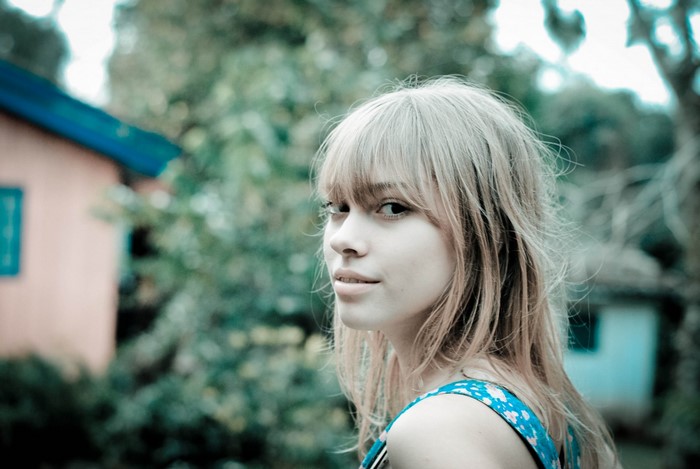 Woman with blond hair in a blue dress