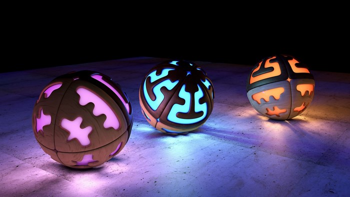 Three glowing geometric spheres on a textured surface