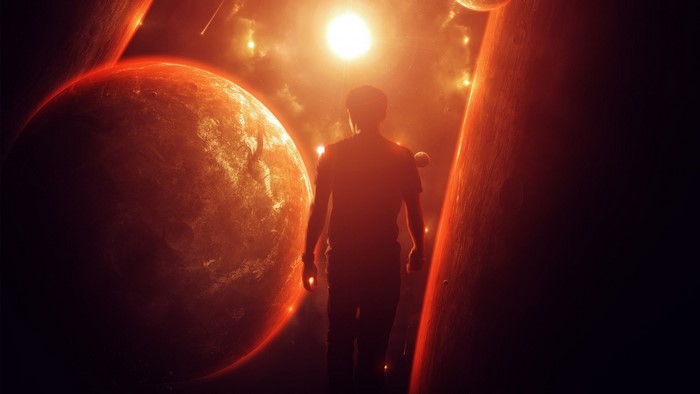 Silhouette of a man walking through a red galaxy with planets