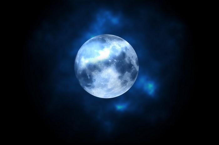 Full moon in the night sky with clouds