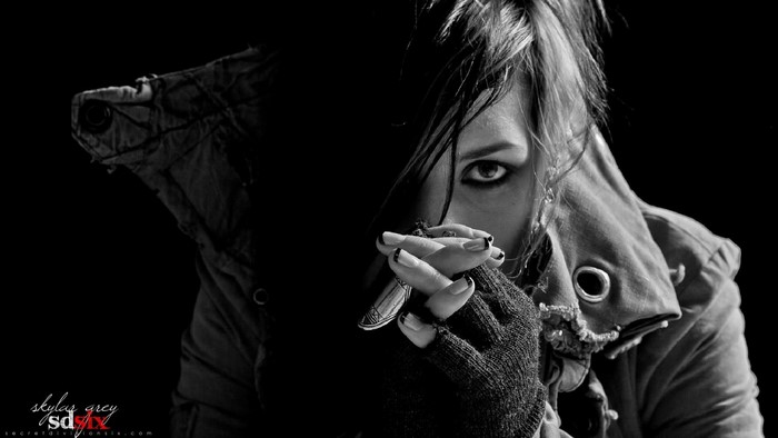 Woman with dark hair and makeup in black and white