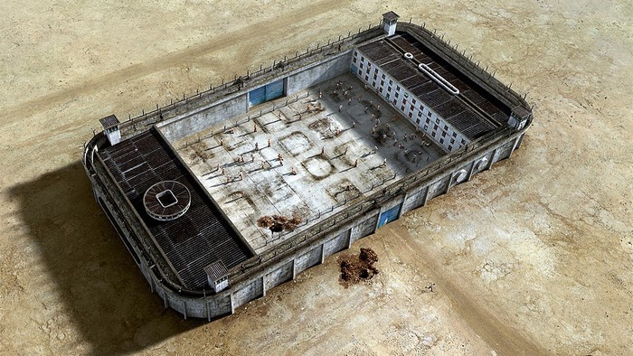 Prison yard with inmates and guard towers