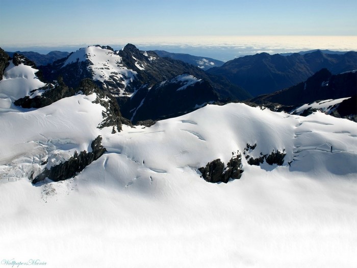Snow-covered mountains under a clear sky
