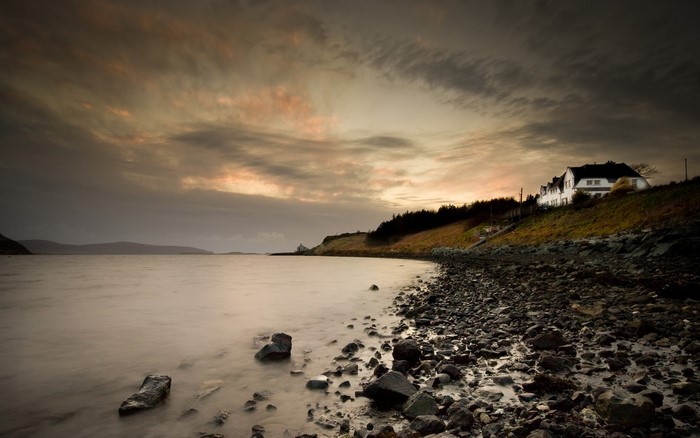 Coastal scene with houses at sunset