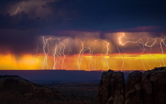 Lightning Storm at Sunset Over Rocky Landscape