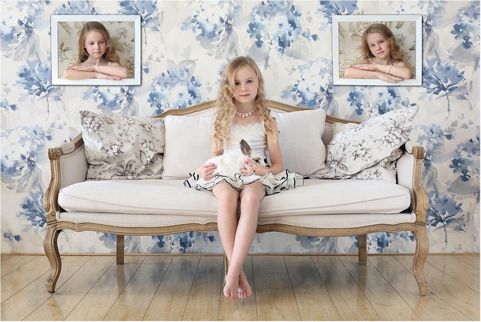 Girl sitting on a couch with framed portraits