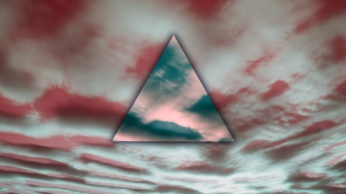 Triangle shape overlaying a red and teal cloudy sky