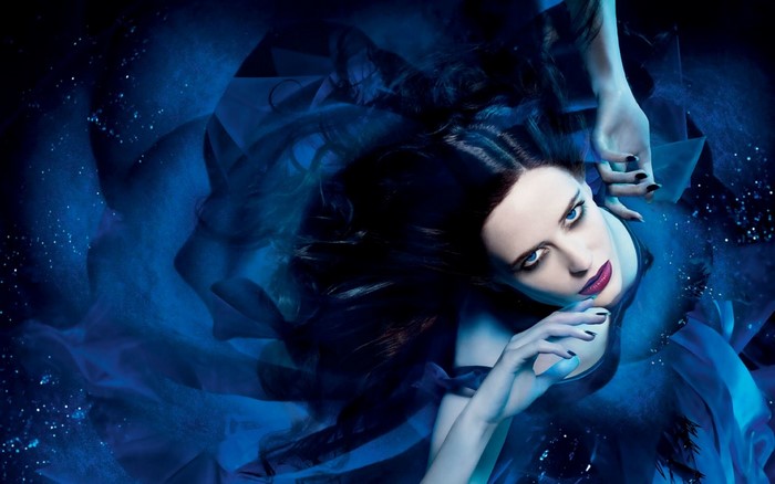 Eva Green in dark blue flowing fabric
