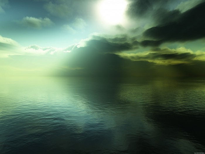 Sunlight breaking through dark clouds over the sea