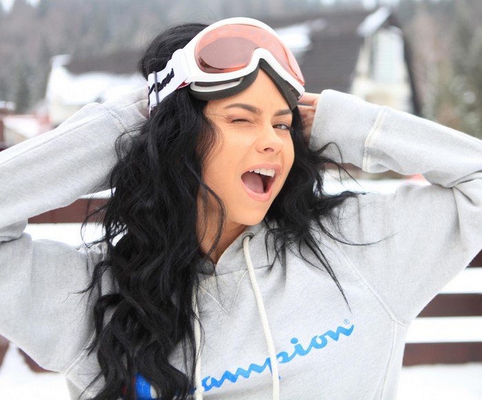 Woman wearing ski goggles and hoodie