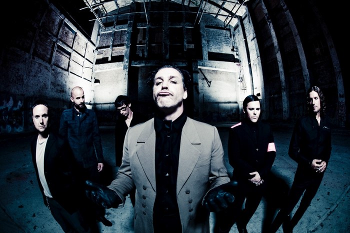 Rammstein band members in a dark industrial building