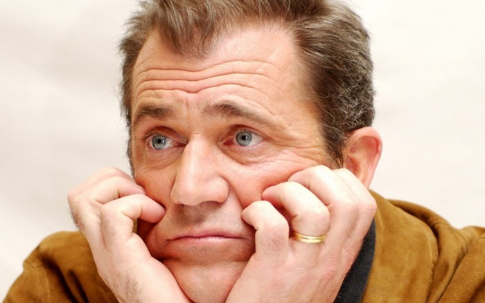 Mel Gibson with hands on cheeks