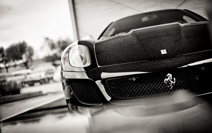 Black Ferrari sports car with prancing horse emblem