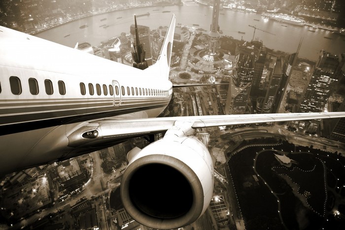 Airplane flying over a city at night