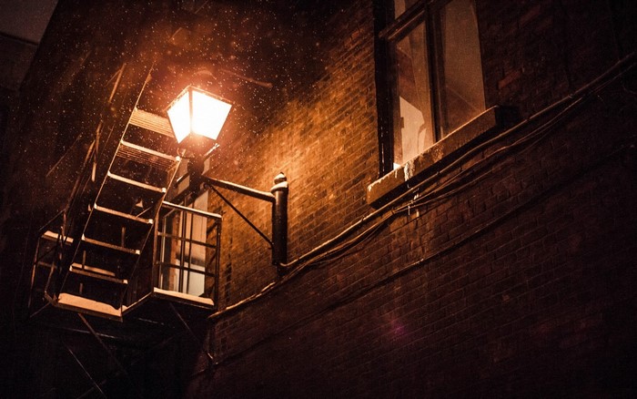 Outdoor metal staircase and lantern at night